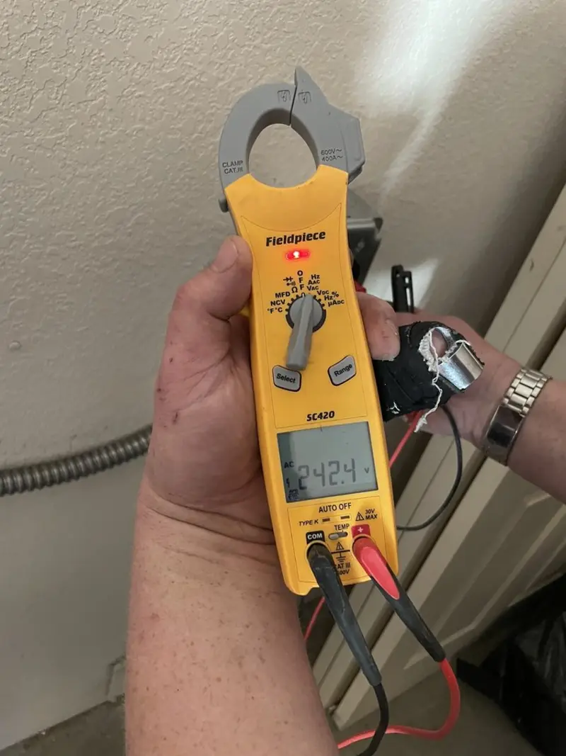 Voltage testing with clamp meter during Outlet Installation in Battlement Mesa